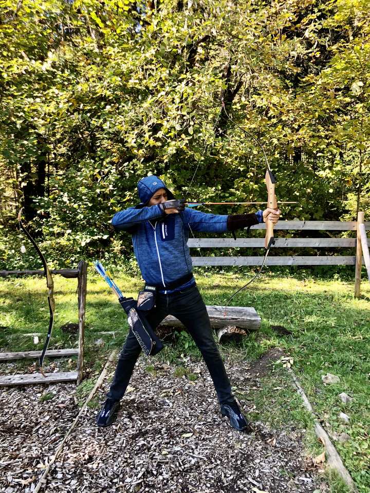 Okey at full draw on a forest archery range