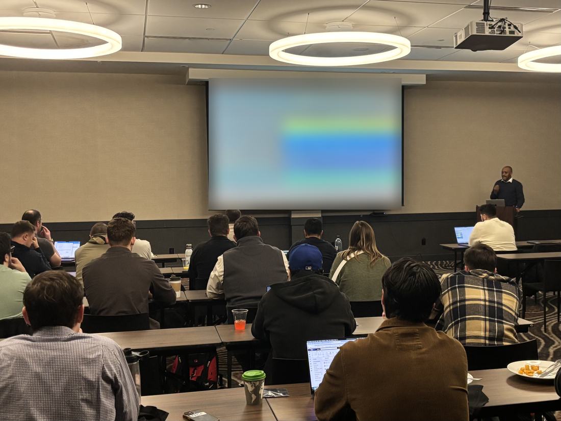 Okey presenting to a full room at a sales kickoff in Denver, Colorado